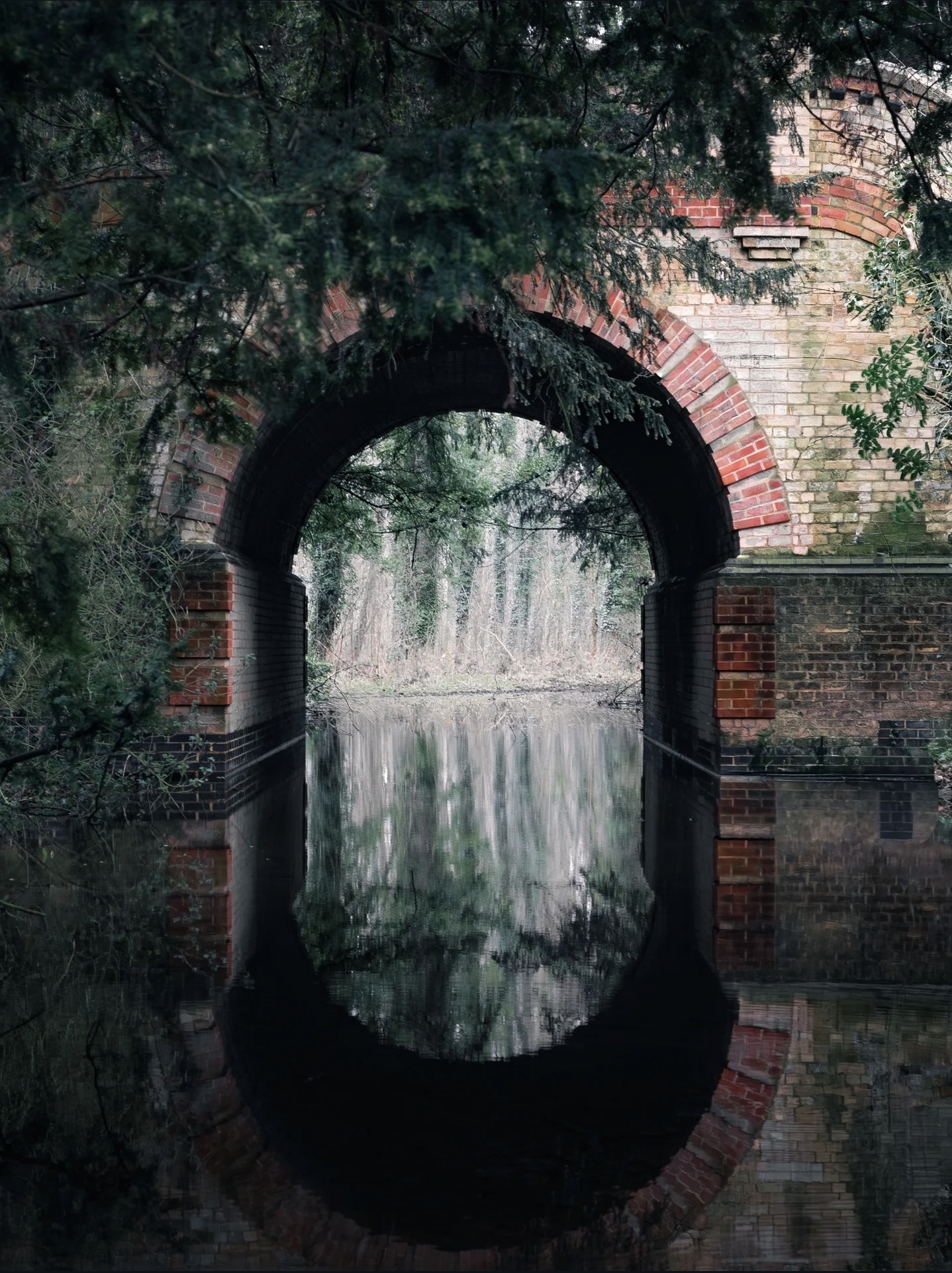 Brick arch reflected in still water